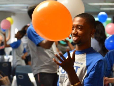 Trio student holding a balloon